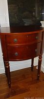 Full view of Bowring bedside table showing two drawers, slender legs, and dark reddish-brown wood finish.