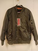 Front view of the men's olive green winter jacket hung on a hanger, showing full zipper and pocket details.