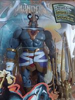 Front close-up of the Mumm-Ra figure showing articulation points and accessory inside sealed plastic packaging.