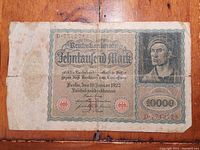 Front view of 1922 Weimar Germany 10,000 mark Reichsbanknote showing portrait of young man and denomination.