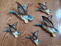 Photo showing all five ceramic flying ducks with detailed color and size variation.