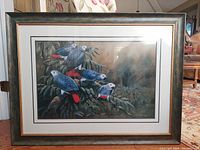 Full view of the framed print showing five African Grey Parrots on branches with detailed foliage background in decorative frame.