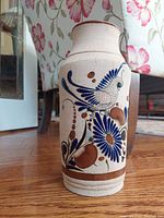 Full view of the vintage Mexican pottery vase showing the quail and floral painted design and vase shape