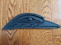 Top view of dark wood carved raven showing detailed eye and feather patterns.