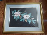Framed vintage print with magnolia flowers, triple matted and under glass in a gilt wooden frame shown front view.