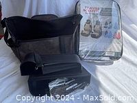Three main items: one black organizer bag, one set of black plastic inserts for console storage, and beige seat covers still sealed in plastic packaging.
