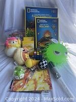 Two National Geographic boxed kits and assorted toys including Squishmallow and small squeeze toys