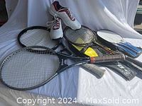 Two Wilson tennis racquets, three badminton racquets, one set of table tennis racquets with ball, and men's Adidas golf shoes displayed together on white surface.