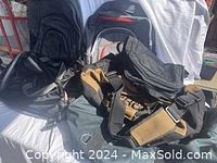 Photo showing multiple travel bags including two Dakine backpacks, Work Pro bag, Lululemon gym bag, and packing cubes.