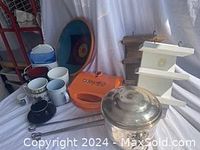 Photo showing vintage silver ice bucket, Babycakes waffle stick maker, wooden shelves, BBQ sticks, water pic, decorative bowl, and various mugs.