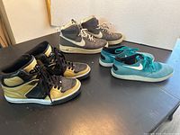 Photo showing all three pairs of men's shoes in size 10.5 on a table, including Nike Air, Osiris, and Nike Lunar models.
