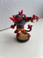 Front angled view of Incineroar Amiibo figure on round base showing character details and stance.