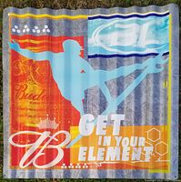 Front view of the corrugated metal sign showing blue surfer silhouette, Bud Light and Budweiser branding, and colorful background with slogan.