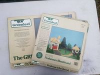 Photo showing the packaging of both Greenleaf wooden building kits: Firehouse & Bandstand and The Greenleaf Village.
