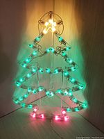 Photo of wireframe Christmas tree light decoration with star lit