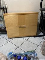 Light Italian wood nightstand with two drawers, front view.