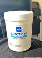 Closed container of Medline Spectrum Advanced hand sanitizing wipes, showing front label with brand and product name, and quantity of wipes per container (150)