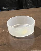 Side angle of the clear plastic animal bowl showing translucent construction and thickness.