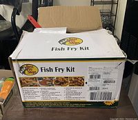 Box labeled Bass Pro Shops Fish Fry Kit with product details visible.