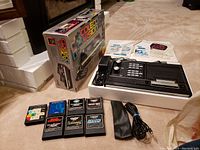 Overview of console, box, controllers, overlay, cartridges and manuals