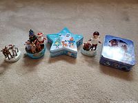 Wide view of the full lot of Rudolph themed ornaments and original tin box
