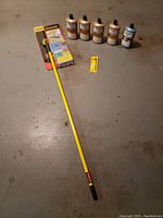 Full lot showing 4 bottles of hard wood reviver, 1 blue bottle of hardwood cleaner, rubbermaid microfiber mop with yellow handle, and Minwax repair marker.