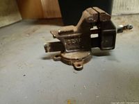 Side view of heavy metal vice clamp showing 'SEARS' branding and screw tightening handle.