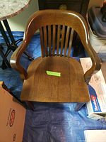 Top view showing the solid wood seat, curved armrests, and vertical slats on the backrest.