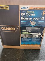 Photo of Camco UltraGuard Pop-up RV Cover box showing front label with product information and branding.