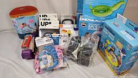 Full view of lot containing various exercise, swimming, insect catcher, and repair kit items