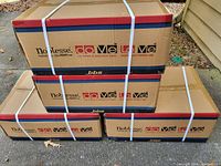 Four large flat boxes stacked: labeled LoMe and other related branding.