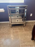 Front view of the mirrored end table.