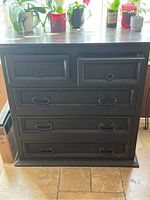Front view of the solid wood side cabinet showing all five drawers and metal ring and curved handles.