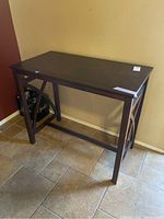 Front and left side angle showing flat wooden top, straight legs, and X-shaped side supports.