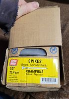 Box showing brand and product details - Grip Rite 10 inch Bright Smooth Shank Spikes, crampons.