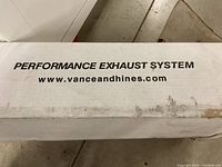 Box showing Vance & Hines branding and website, indicating a performance exhaust system inside.