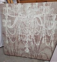 Photo of a large square picture depicting a beige and white chandelier illustration on a textured background.