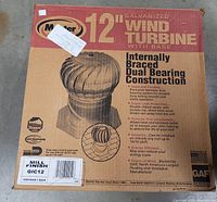 Box of 12 inch galvanized wind turbine with base, labeled 'Master 12 inch Wind Turbine' featuring internal braced dual bearing construction, weather resistant.