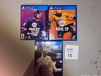Front covers of three PS4 game cases showing NHL 20, NHL 19, and FIFA 18 with cover art featuring NHL players and Cristiano Ronaldo for FIFA.
