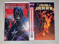Two comics shown, Ultimate Comics 3 #5 and a Spider-Man House of M comic with a flaming Spider-Man cover