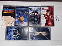 Six PSP movie UMD cases front showing titles including Stewie Griffin, Monty Python and the Holy Grail, The Last Stand, Ghost In The Shell, X2, and X-Men.