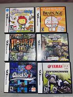 Six Nintendo DS game cases with visible cover art and cartridges arranged on flat surface.
