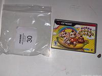 Front photo of the Monkey Ball game cartridge box with game artwork showing three monkeys on a banana, brand and title text.