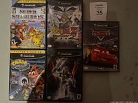 Front cover photo showing five Nintendo GameCube game cases in a grid layout: Super Smash Bros. Melee, Dragon Ball Z Budokai 2, Cars, Crash Bandicoot: Wrath of Cortex, and Bionicle Heroes.
