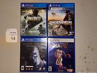 Four video games laid flat on floor; 3 PS4 games and 1 PS5 game included; cases and covers visible