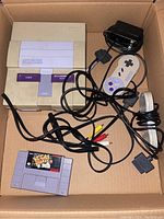 Box with SNES console, power adapter, two wired controllers, AV cable, and Vegas Stakes game cartridge for sale.