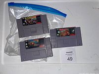 Front view of the three SNES Donkey Kong game cartridges inside a resealable plastic bag showing the game labels.
