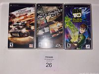 Front view of three PSP game cases: Need for Speed Most Wanted 5-1-0, Speed Racer: The Videogame, and Ben 10 Alien Force