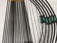 Photo showing the full length of the arrows with black shafts and feather fletching.