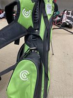 Side view of Cleveland Golf green and black junior carry stand bag showing logo and structure